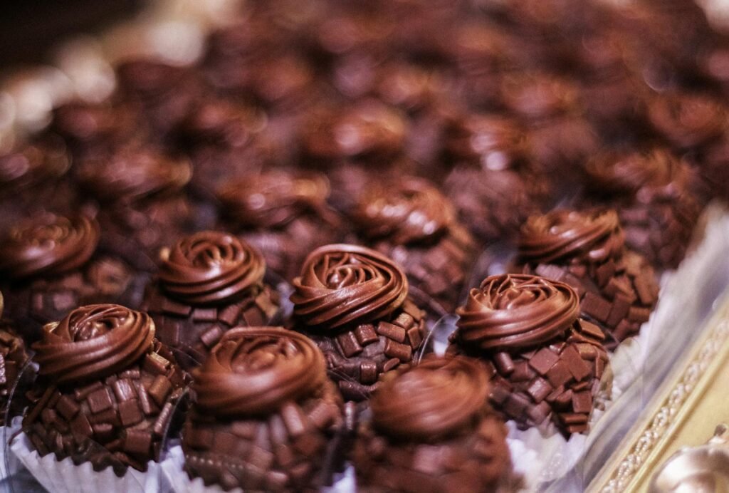 Close-up of rich, handmade Brazilian chocolate truffles arranged artfully on a tray.