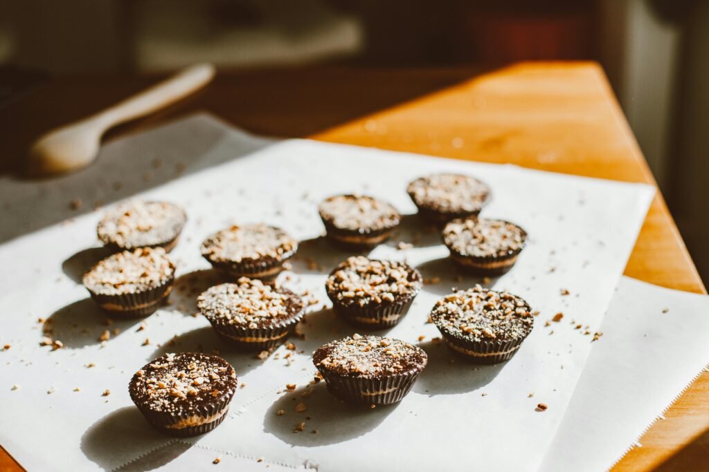 Freshly baked chocolate cupcakes on parchment, inviting indulgence.